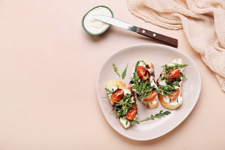 Plate with tasty sandwiches and cutter on color backgroundの写真素材