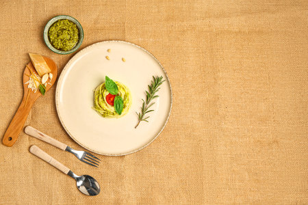 Plate with tasty pesto pasta with tomato on tableの写真素材