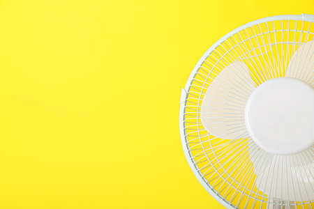 electric fan on yellow backgroundの写真素材