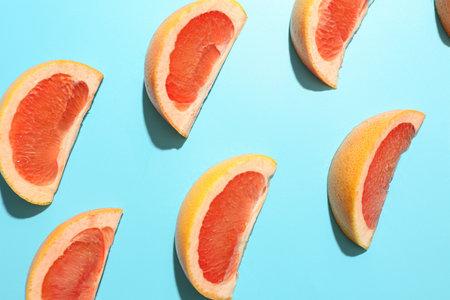 Composition with pieces of ripe grapefruit on color background, closeupの写真素材