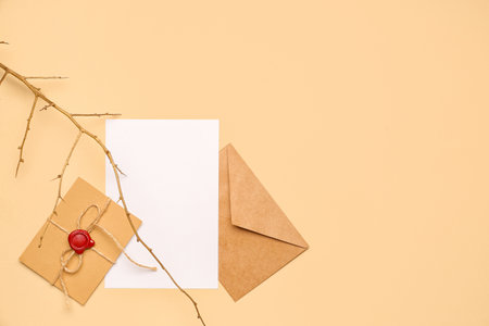 Composition with envelopes, blank card and tree branch on color backgroundの写真素材