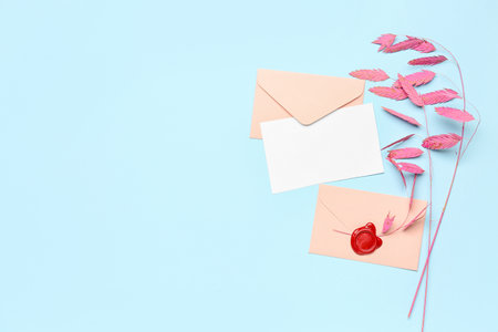 Composition with blank card, envelopes and dried flowers on color backgroundの写真素材