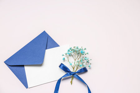 Composition with blank card, envelope and gypsophila flowers on white backgroundの写真素材