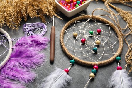 Materials for making dream catcher on dark background, closeup