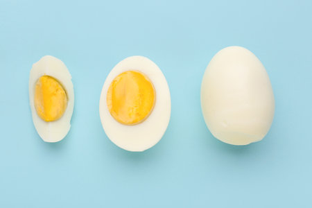 Delicious boiled eggs on blue backgroundの写真素材