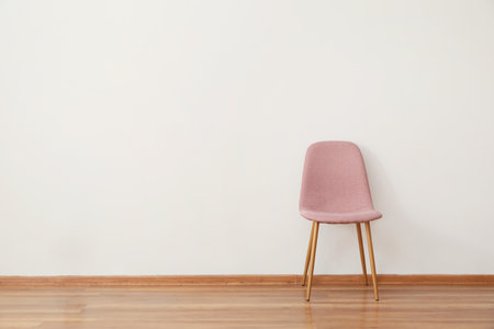Stylish chair near white wall in roomの写真素材
