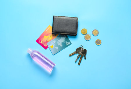 Wallet with keys from house and disinfectant on color backgroundの写真素材