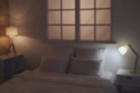 Interior of modern hotel room with glowing lamps at night, blurred viewの写真素材