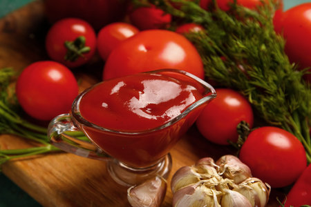 Gravy boat with tasty ketchup on table, closeupの写真素材