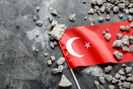 Stone debris with Turkish flag on dark background. Turkey earthquake conceptの写真素材