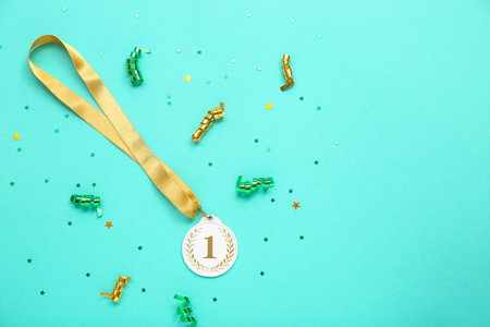 First place medal with stars and serpentine on color backgroundの写真素材