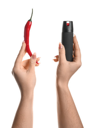 Woman with spray and chili pepper on white backgroundの写真素材