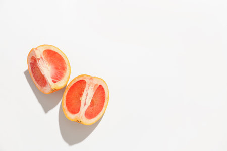 Pieces of ripe grapefruit isolated on white backgroundの写真素材
