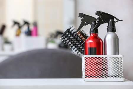 Organizer with hair sprays and brushes on table in beauty salon, closeupの写真素材
