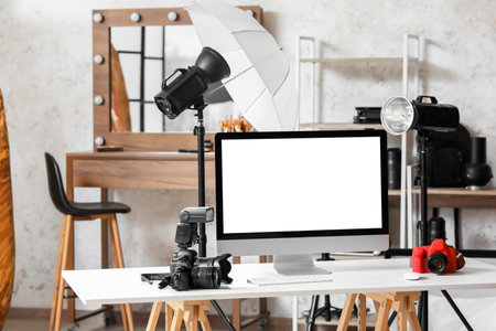 Modern photographer's workplace with computer in studioの写真素材