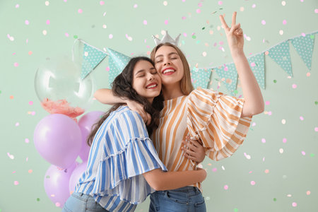 Happy young women celebrating Birthday on green backgroundの写真素材