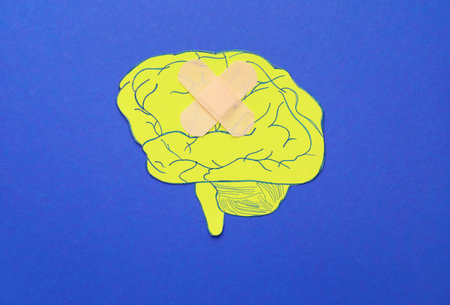 Paper brain and medical patch on color background. concept of dementiaの写真素材