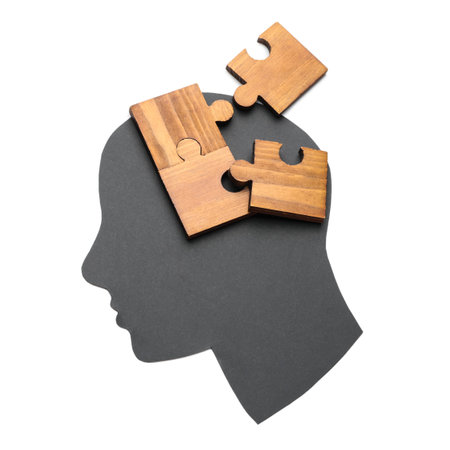 Paper human head and pieces of jigsaw puzzle on white background. concept of dementiaの写真素材