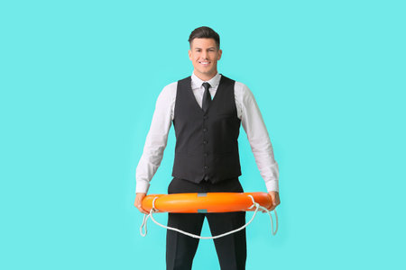Young businessman with lifebuoy on color backgroundの写真素材