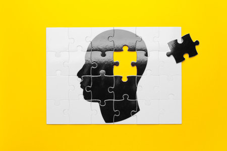 Jigsaw puzzle with human head on color background. concept of dementiaの写真素材