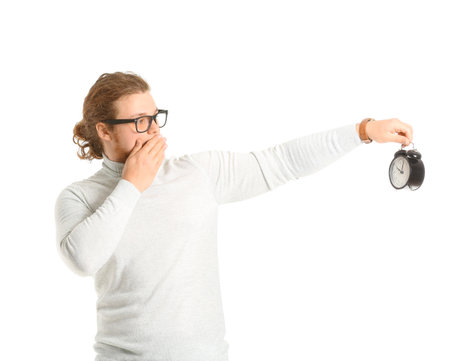 Shocked man with alarm clock on white backgroundの写真素材