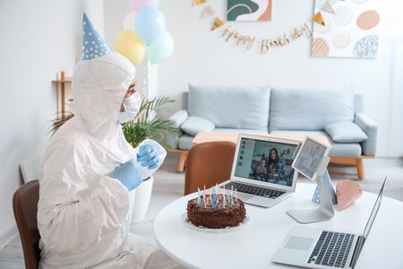 Asian man video chatting with friends on his Birthday at home. concept of epidemicの写真素材