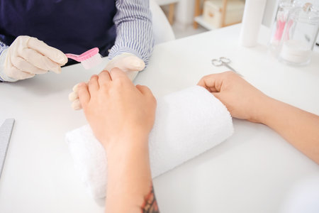 Manicure master working with male client in beauty salon, closeupの写真素材