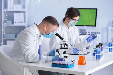 Scientists working with samples in laboratoryの写真素材