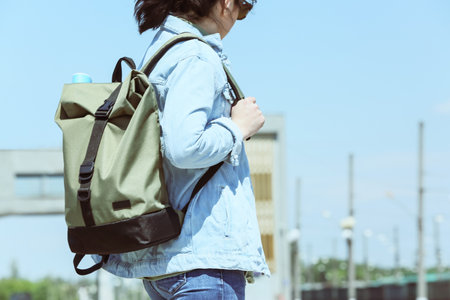 Female traveler with backpack outdoorsの写真素材