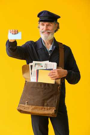 Handsome old postman on color backgroundの写真素材