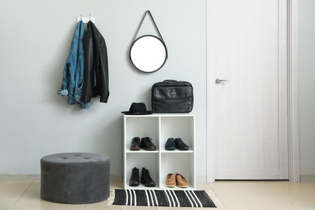 Shelving unit with shoes and accessories in stylish modern hallwayの写真素材