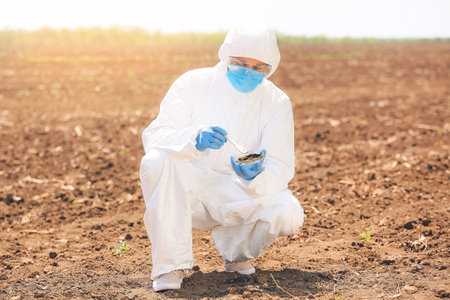 Scientist studying samples of soil in the fieldの写真素材
