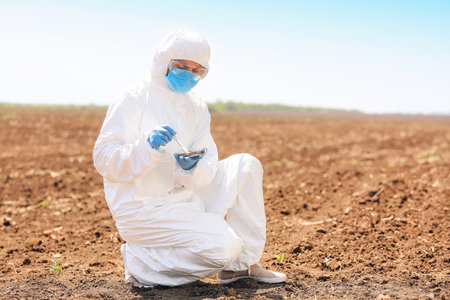 Scientist studying samples of soil in the fieldの写真素材