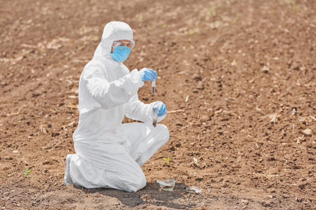 Scientist studying samples of soil in the field