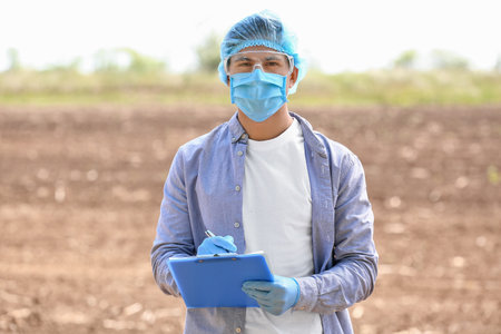Scientist studying samples of soil in the fieldの写真素材