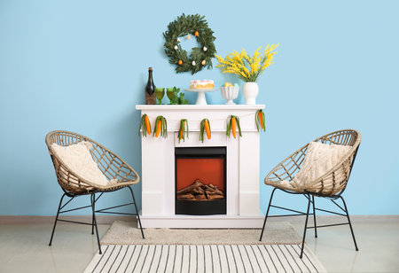 Interior of living room with Easter decor on fireplace and armchairsの写真素材