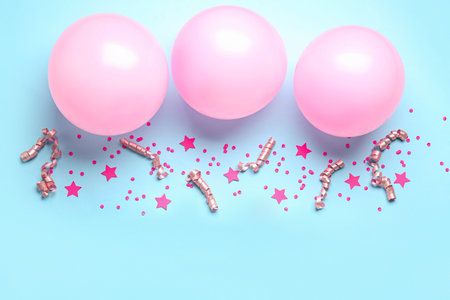 Pink balloons, stars, ribbons and serpentine on blue backgroundの写真素材