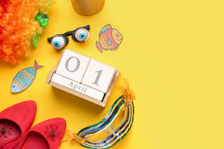 Calendar with date of April Fool's Day and funny decor on yellow backgroundの写真素材