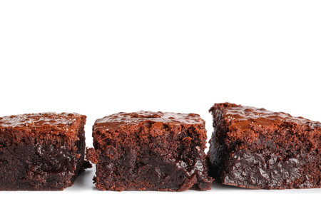 Pieces of tasty chocolate brownie isolated on white background, closeupの写真素材