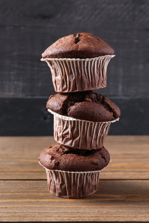 Tasty chocolate cupcakes on wooden tableの写真素材