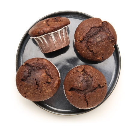 Plate with tasty chocolate cupcakes isolated on white backgroundの写真素材