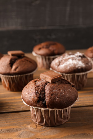 Tasty chocolate cupcakes on wooden tableの写真素材