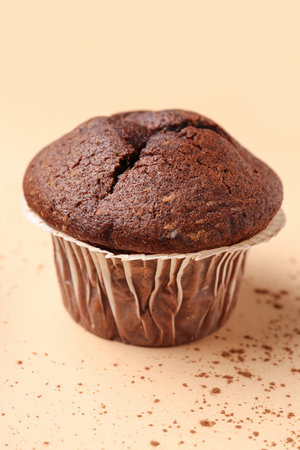 Tasty chocolate cupcakes on beige backgroundの写真素材