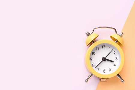 Vintage alarm clock on color backgroundの写真素材