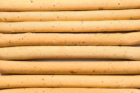 Tasty Italian Grissini as background, closeup