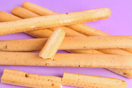 Tasty Italian Grissini on lilac background, closeupの写真素材