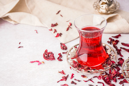 Glass of Turkish hibiscus tea on white tableの写真素材