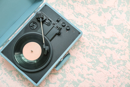 Record player with vinyl disk on grunge backgroundの写真素材