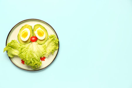 Plate with funny breakfast in shape of owl on blue backgroundの写真素材