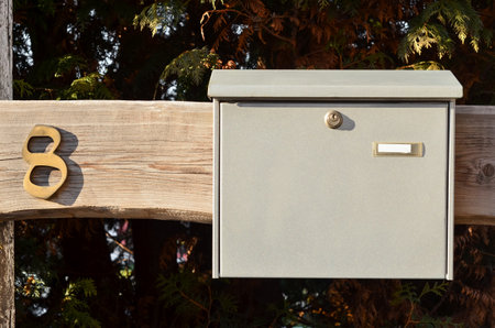 View of metal mailbox on wooden plank, closeupの写真素材